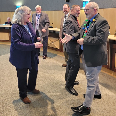 photo of Jan 2024 Employee of the Month Vanessa Fulkerson shaking hands with Levy Court Commissioners after ceremony